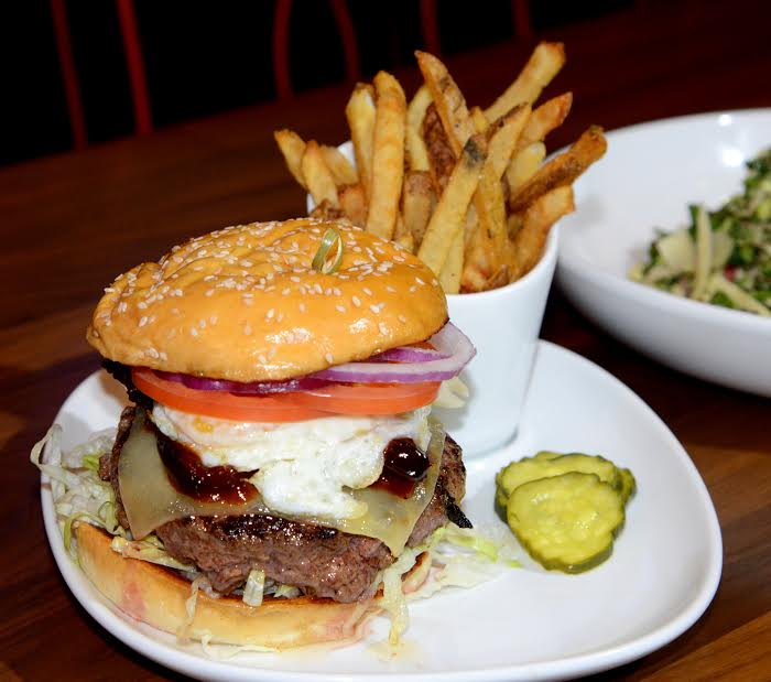 Tony C's Sports Bar and Grill -&nbsp;#25 Burger&nbsp;– Vermont cheddar, crispy pork belly, fried egg, smokey hoisin sauce, sesame brioche, served with hand-cut French Fries&nbsp;