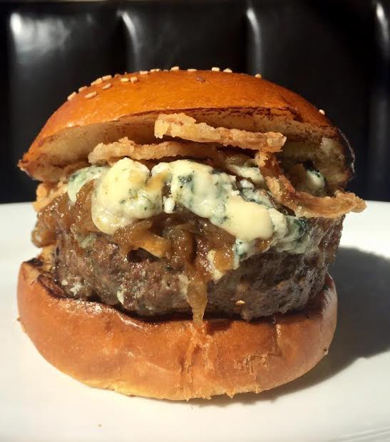 5 Napkins -&nbsp;Onion Blue Burger - Ground beef, Maytag blue cheese, caramelized onions. crispy shallots on a sesame&nbsp;seed brioche roll.&nbsp;